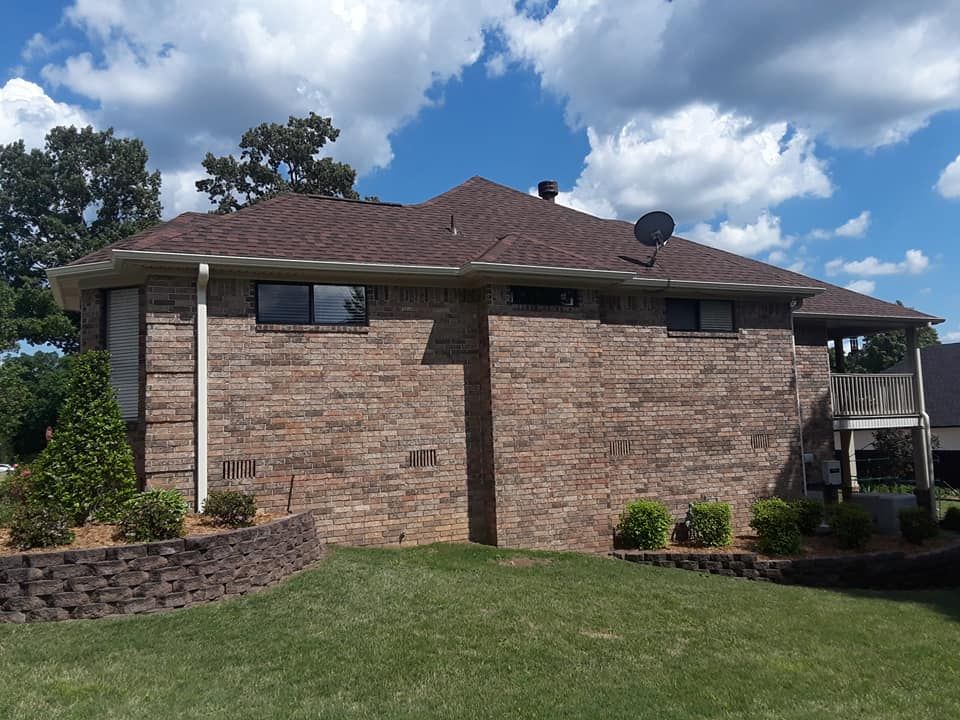 A brick house with a satellite dish on the roof