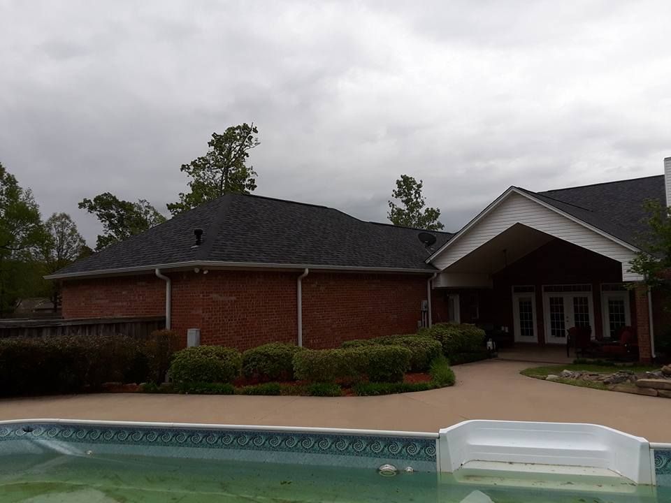 A house with a swimming pool in front of it