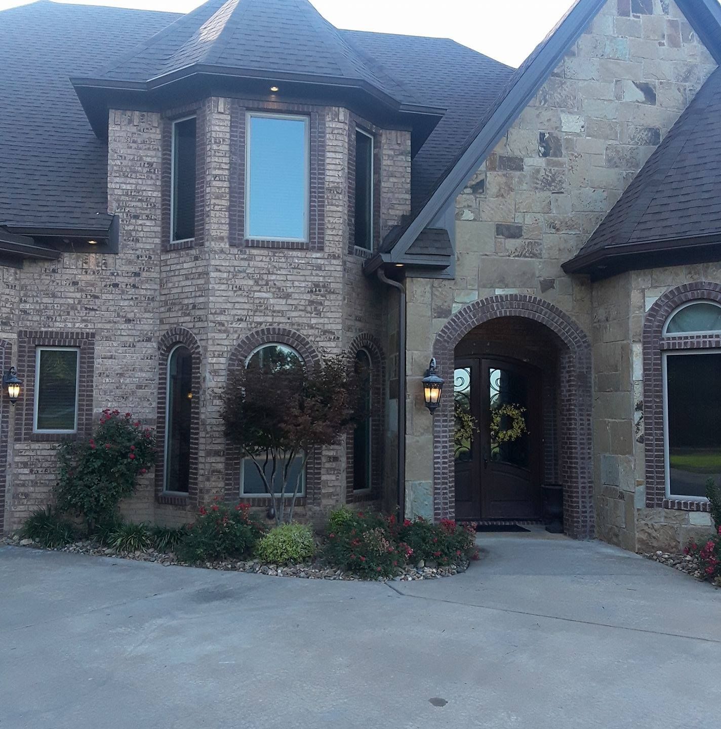 A large brick house with a wreath on the door