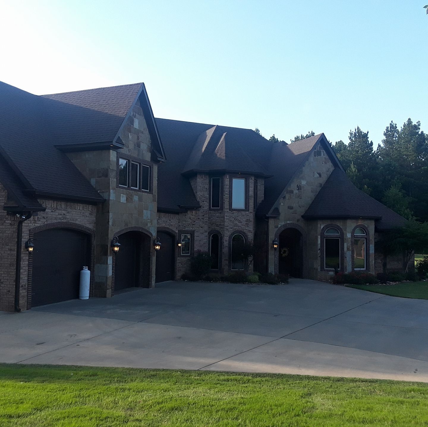 A large brick house with a large driveway