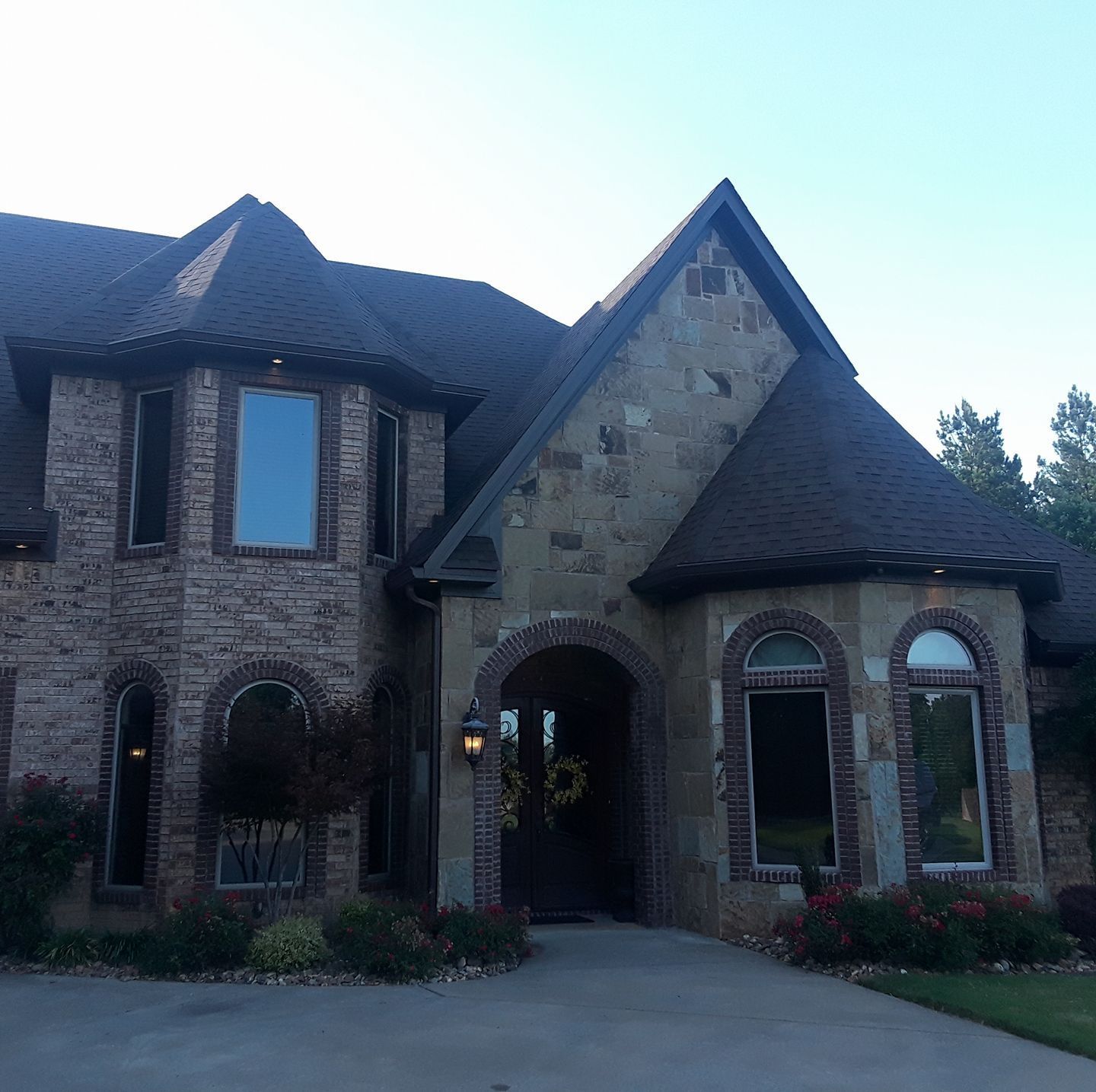 A large brick house with a wreath on the front door