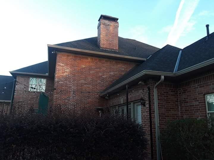 A large brick house with a chimney on the roof
