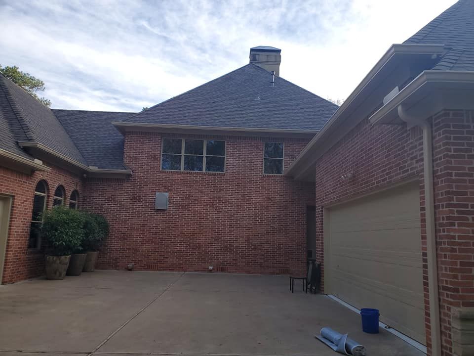A large brick house with a garage and a driveway