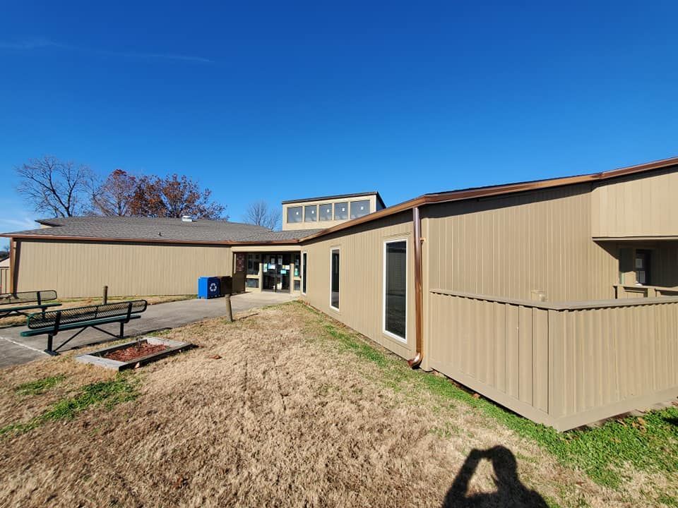 A large building with a picnic table in front of it.