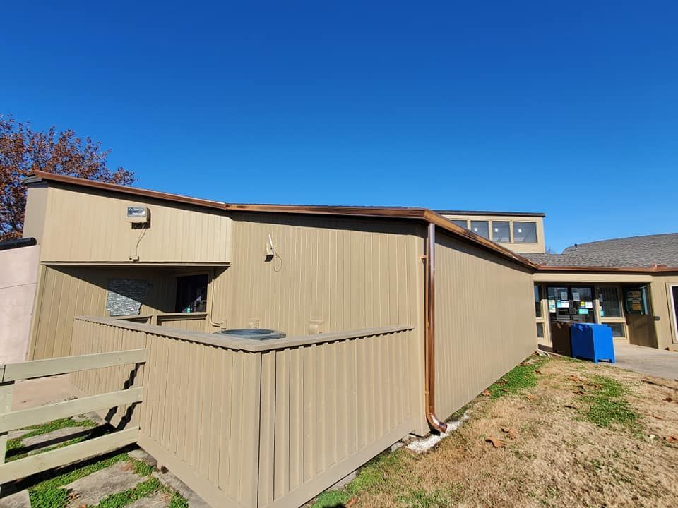 A large building with a picnic table in front of it.