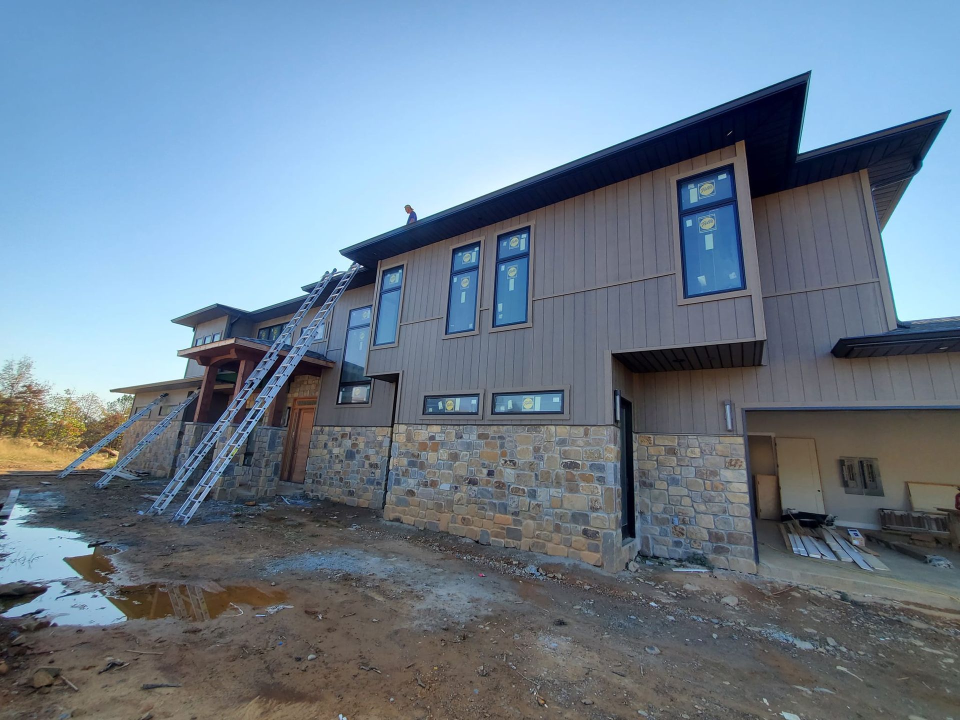 A large house with a lot of windows is being built.