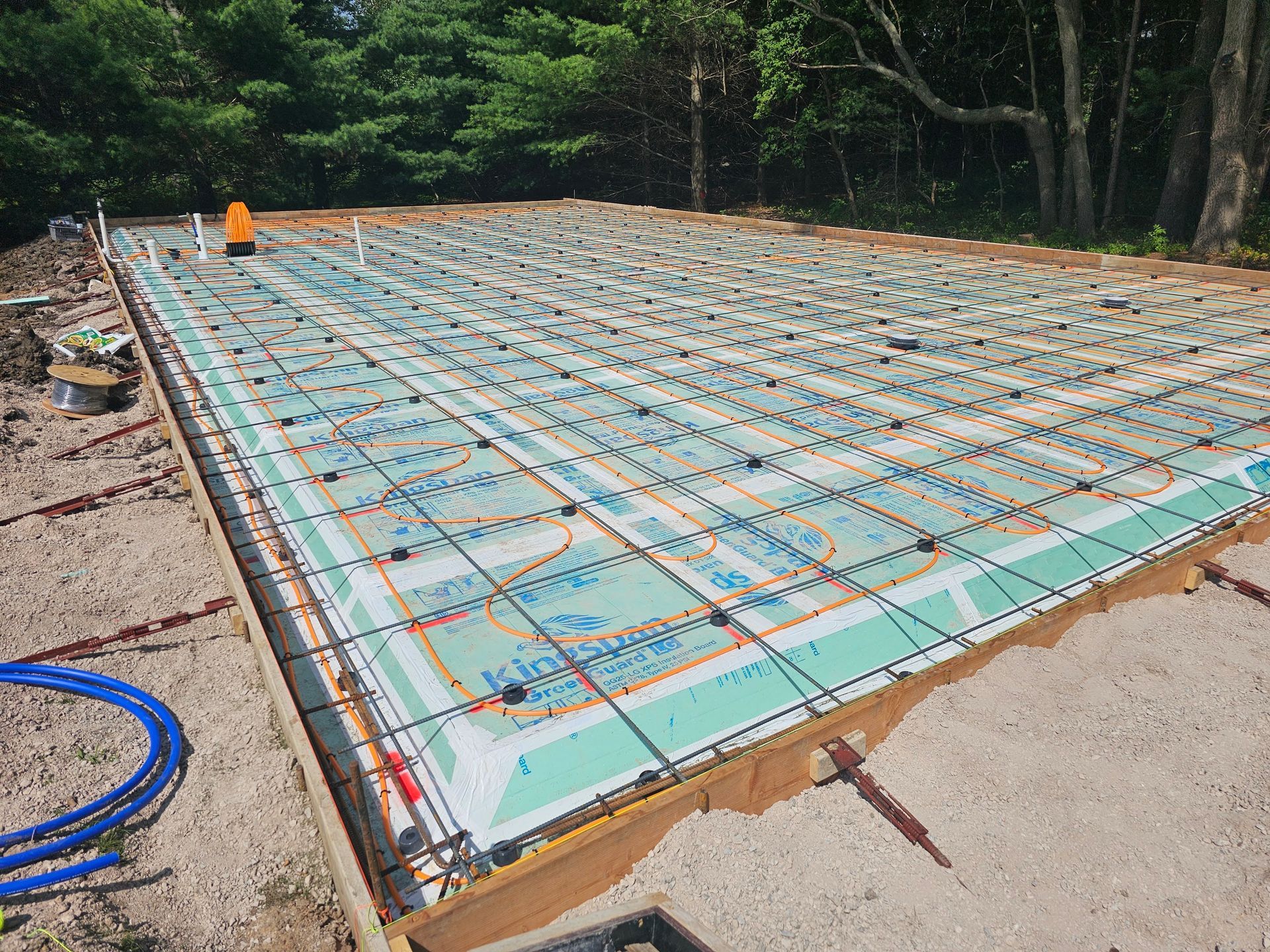 A concrete foundation is being built in a backyard.