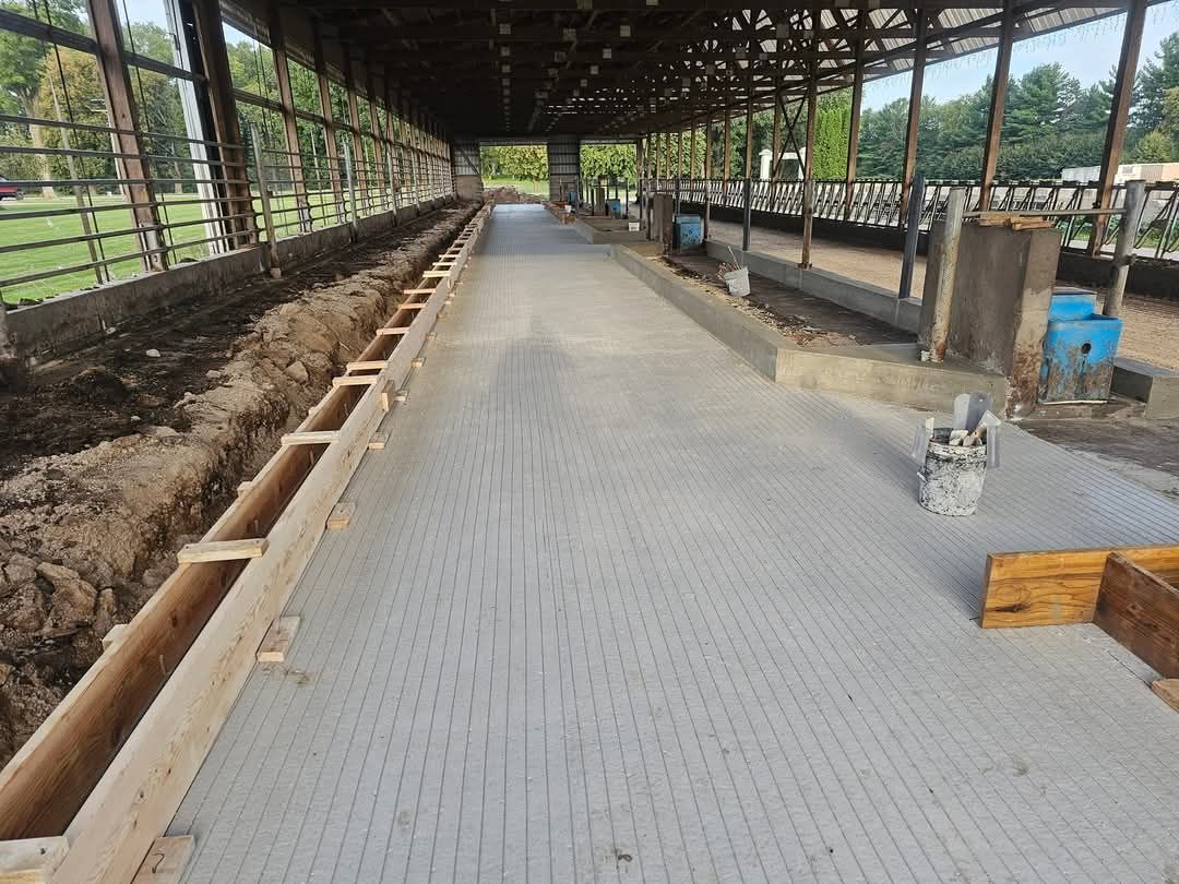 A concrete floor in a barn that is being built