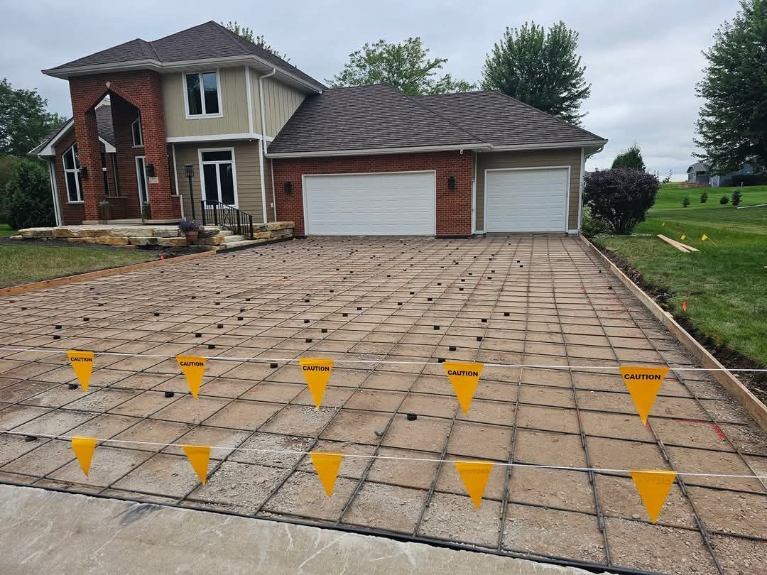 A driveway is being built in front of a house.