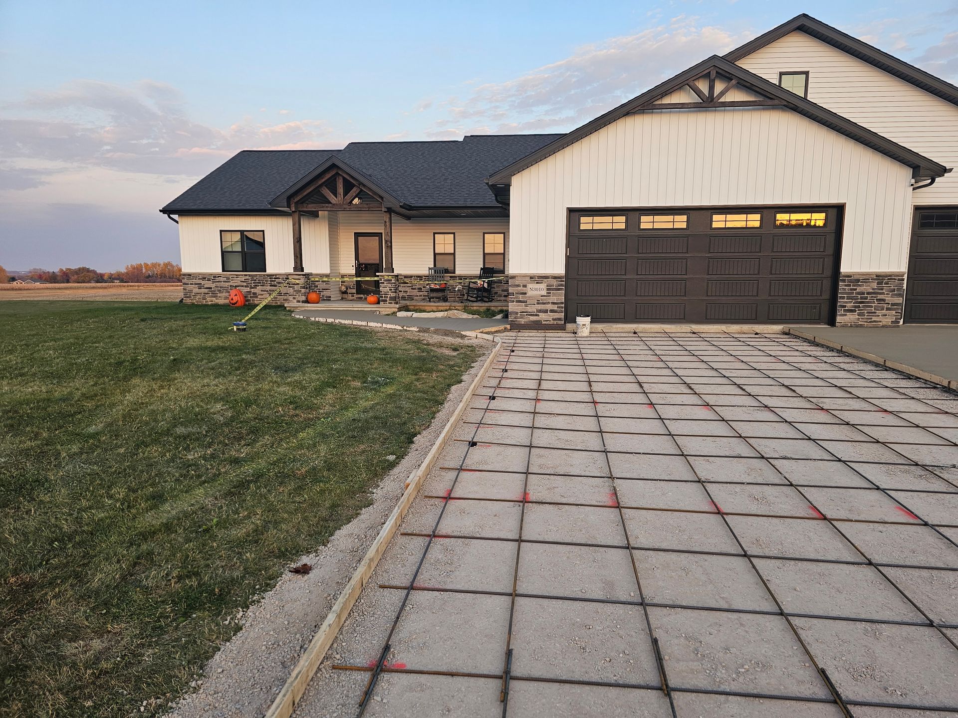 A house with a concrete driveway in front of it.
