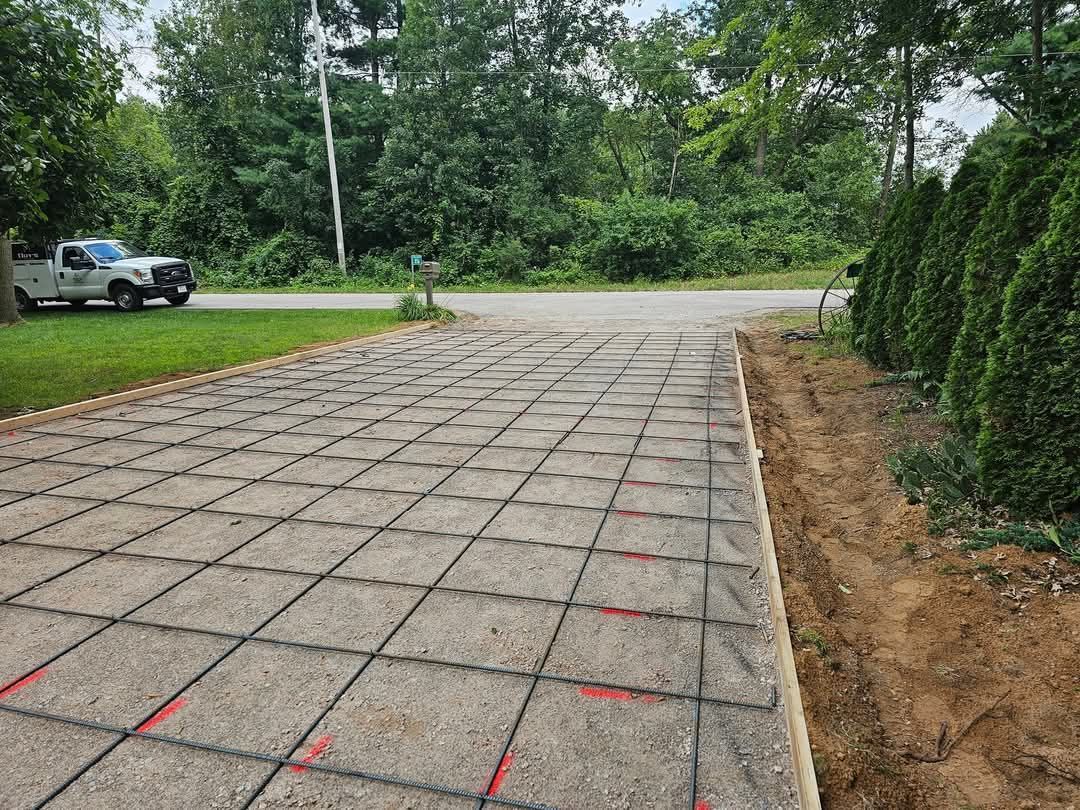 A concrete driveway is being built next to a road.