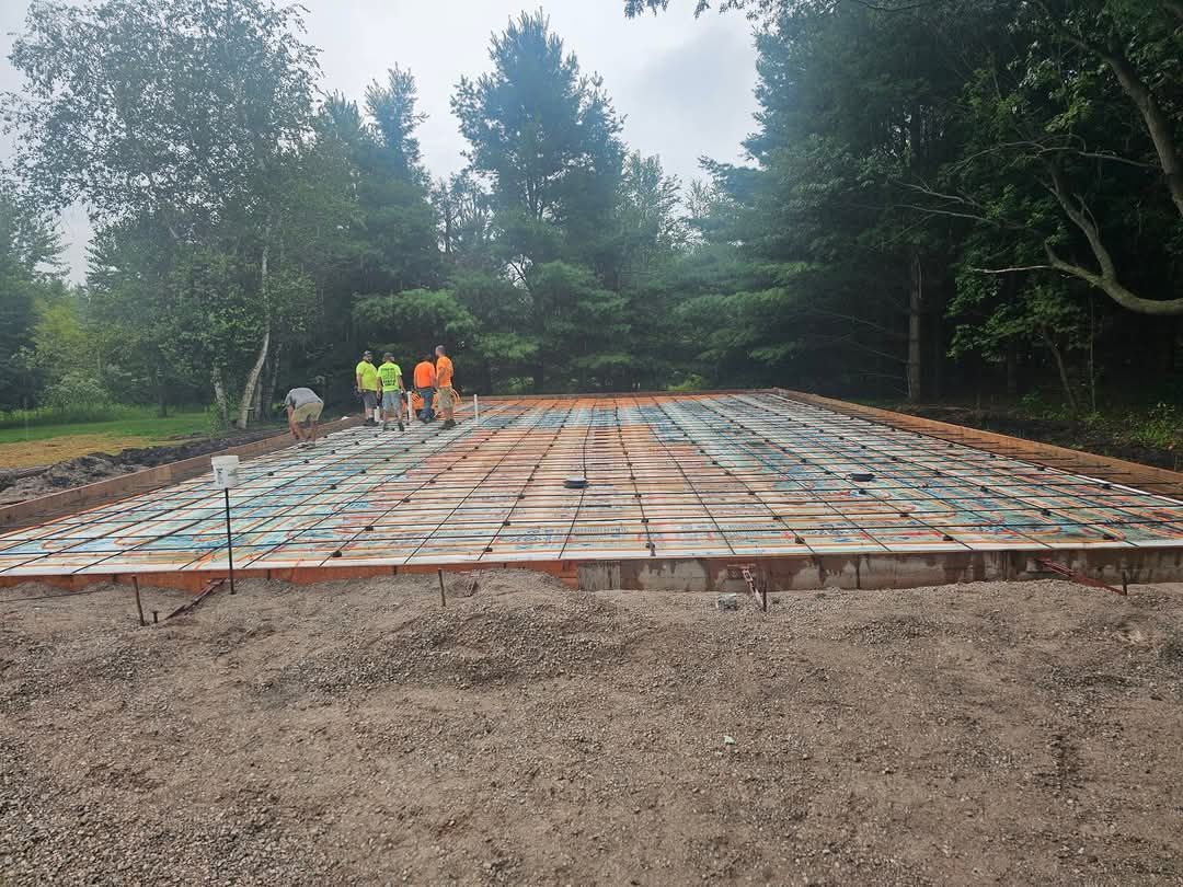 A group of people are standing on top of a concrete slab.