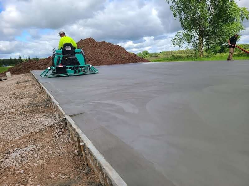 A man is riding a machine on a concrete surface.