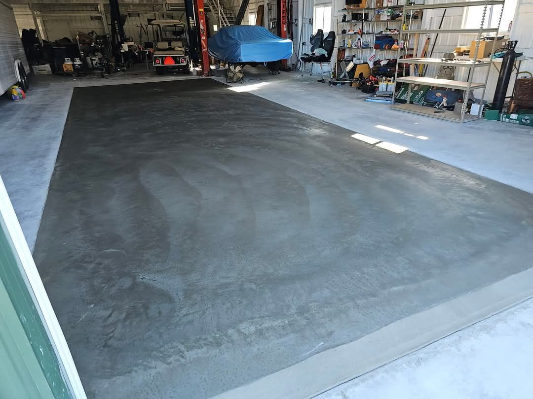A concrete floor is being installed in a garage.