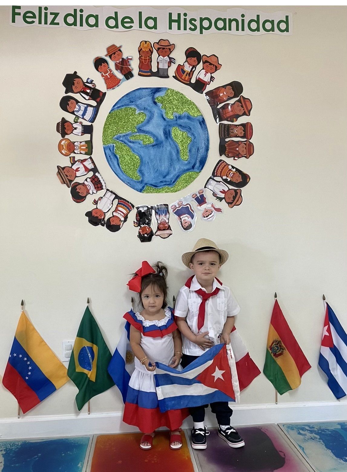 girl and boy in costume with a flag