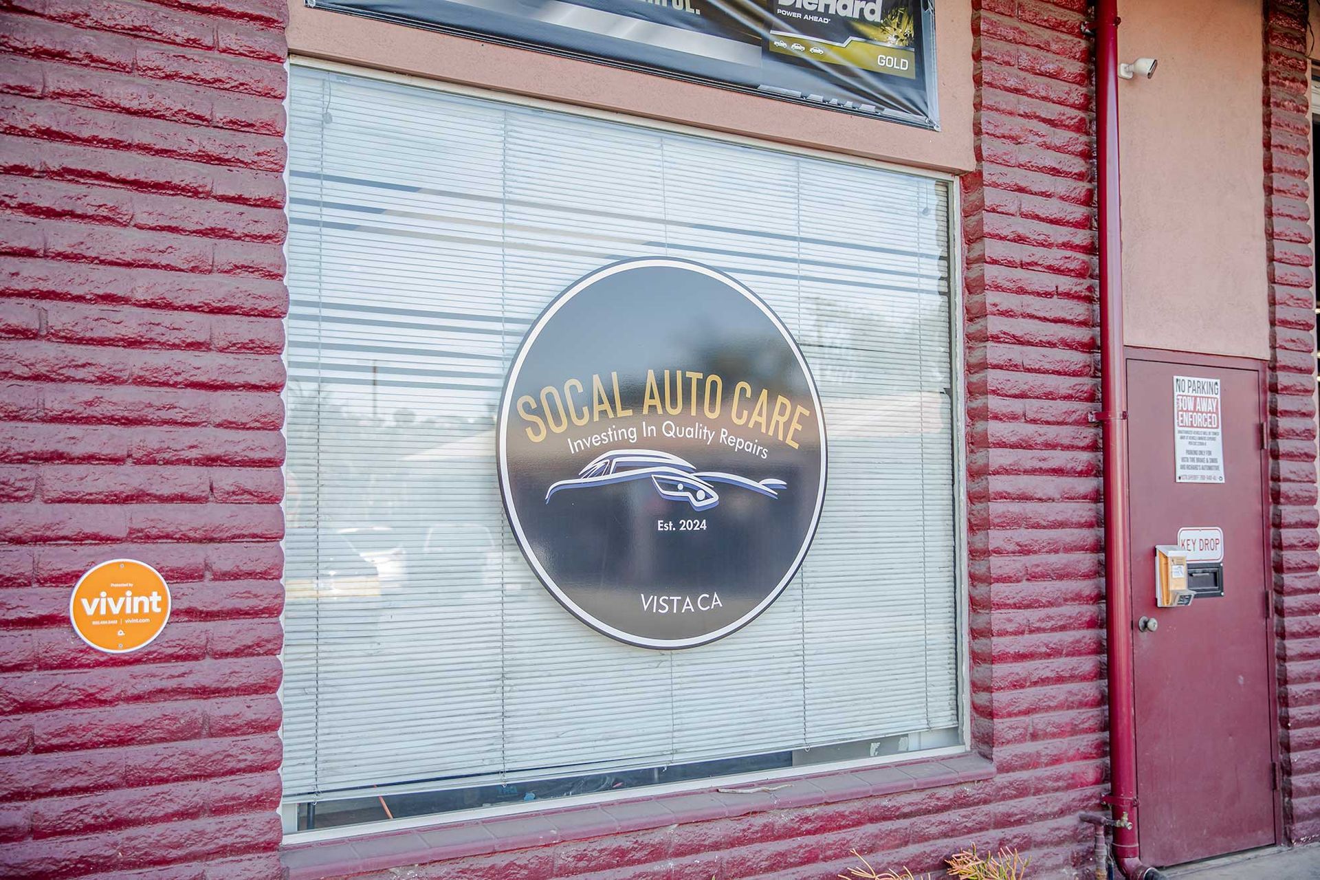 Storefront window with a circular “Soul Auto Care” sign on a red brick building
