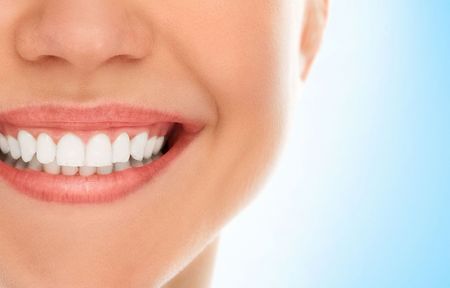 a close up of a woman's smile with white teeth