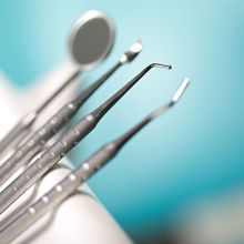 a set of dental instruments including a mirror and tweezers