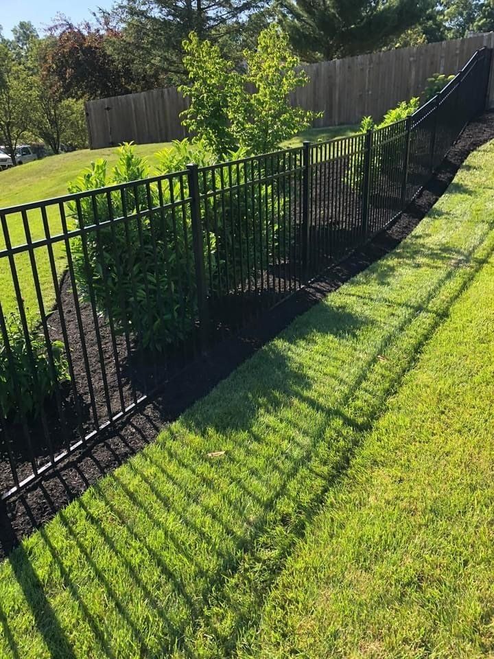 A well-maintained fence securing a beautiful yard