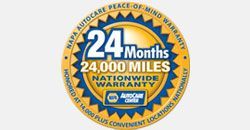 A yellow and blue circle with the words 24 months 24000 miles nationwide warranty on it.