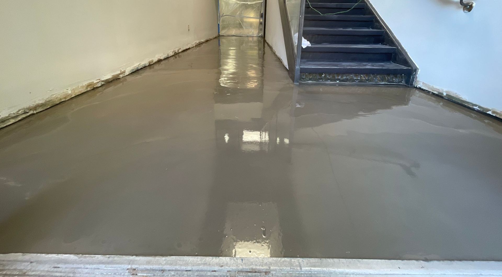 Self-leveling was applied to smooth and level the concrete subfloor