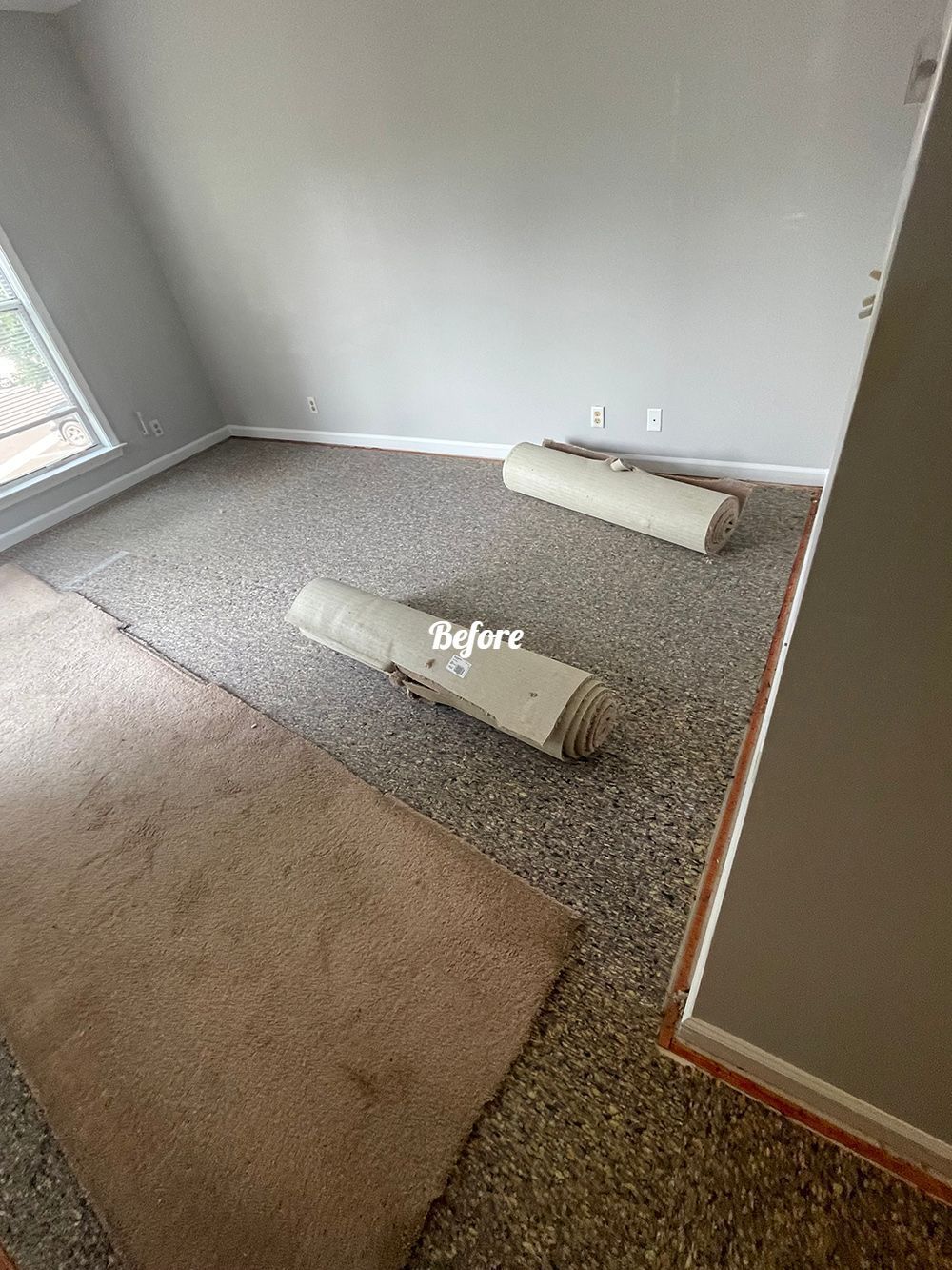 A room with a lot of rolls of carpet on the floor.