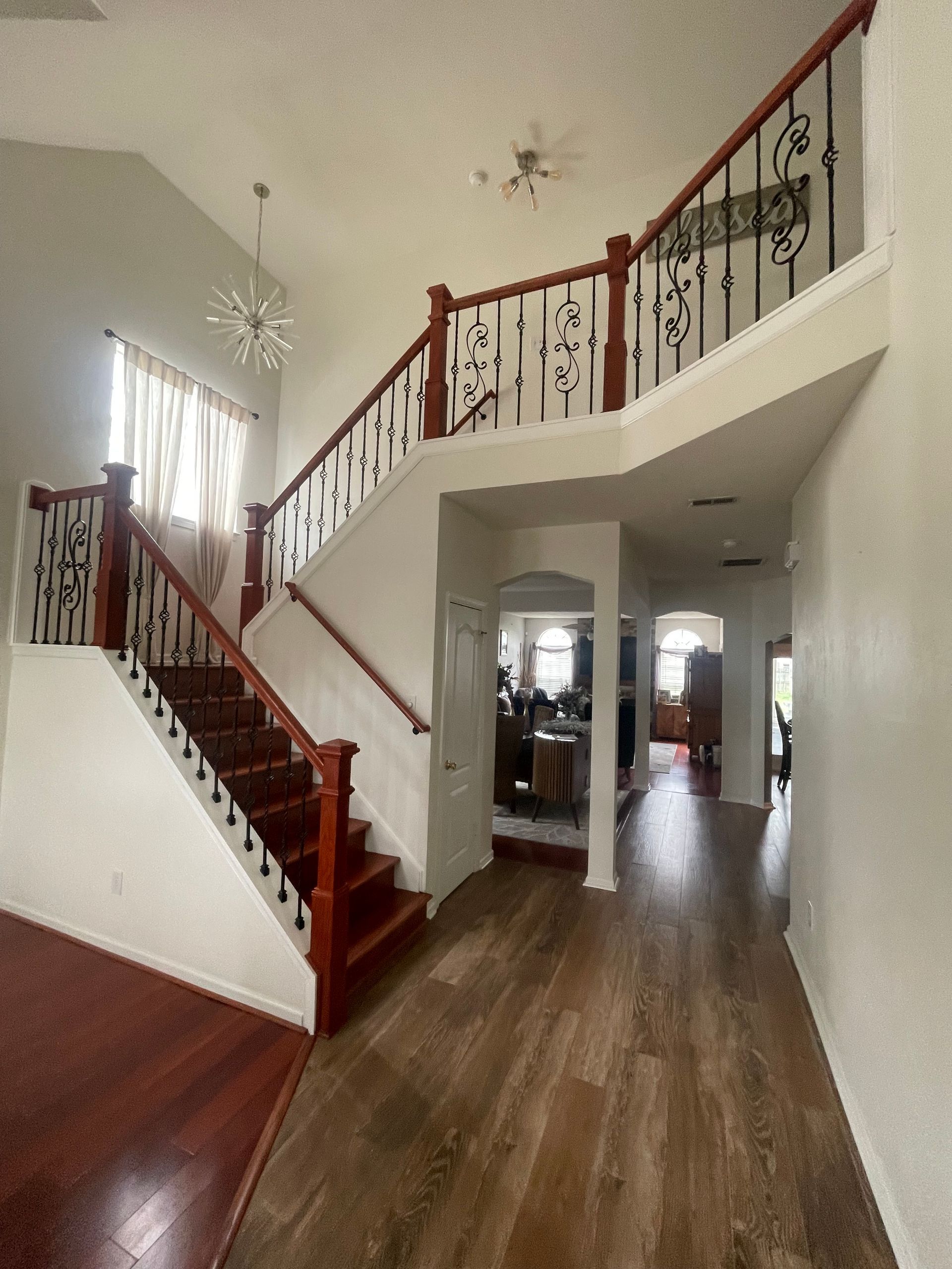 A hallway with stairs leading up to the second floor