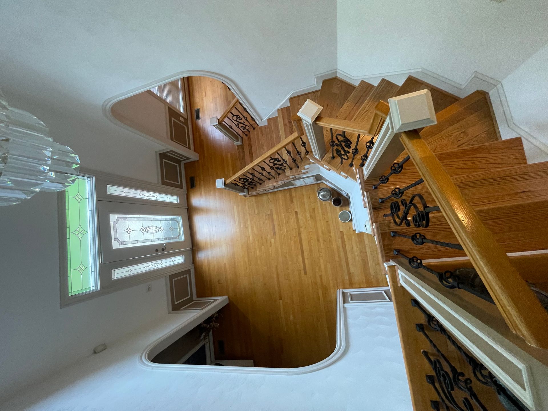 An aerial view of a wooden staircase in a house.