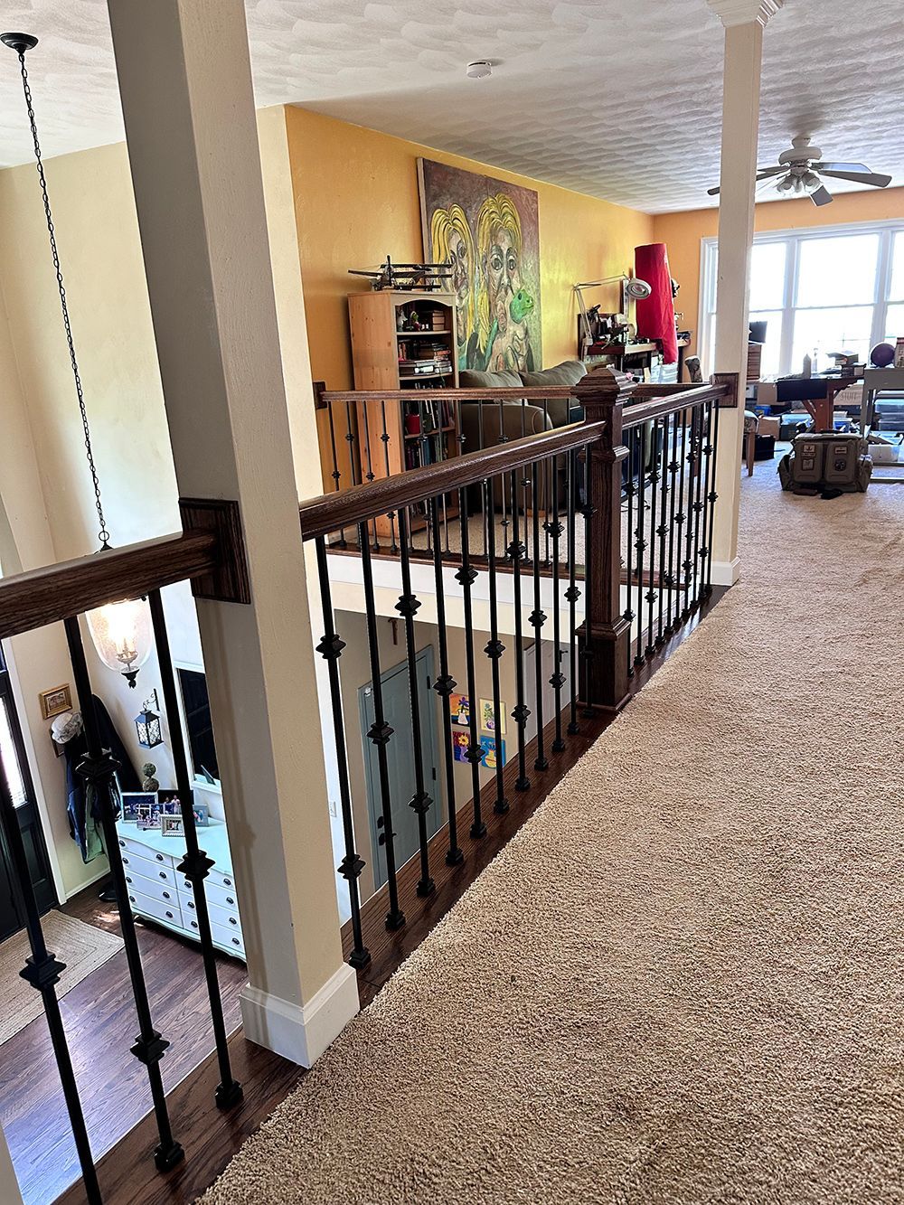 A view of a living room from the second floor of a house.