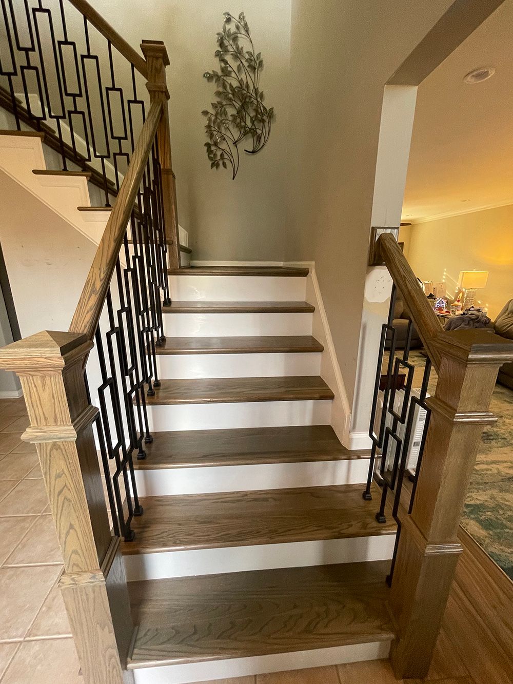 A staircase with wooden steps and a metal railing in a house.
