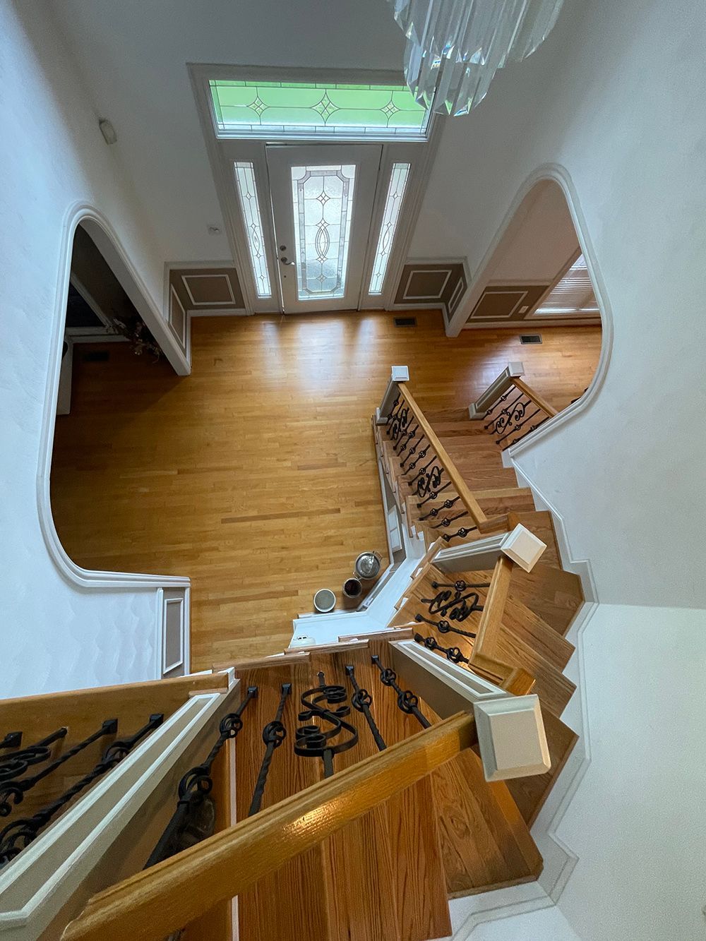 An aerial view of a wooden staircase in a house.