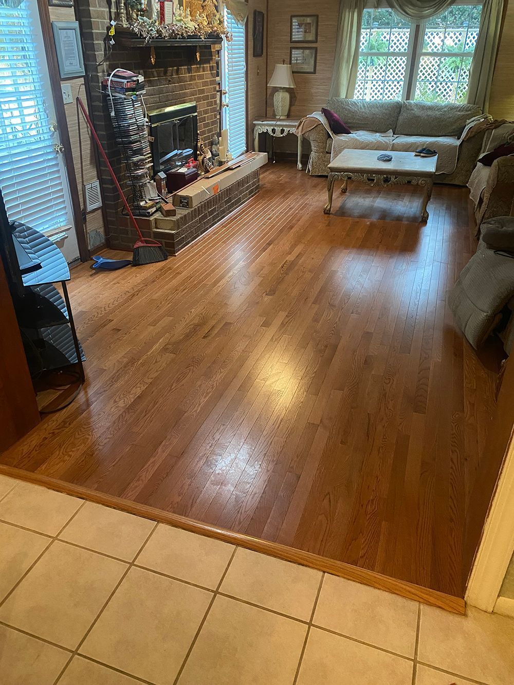 A living room with hardwood floors and a fireplace.