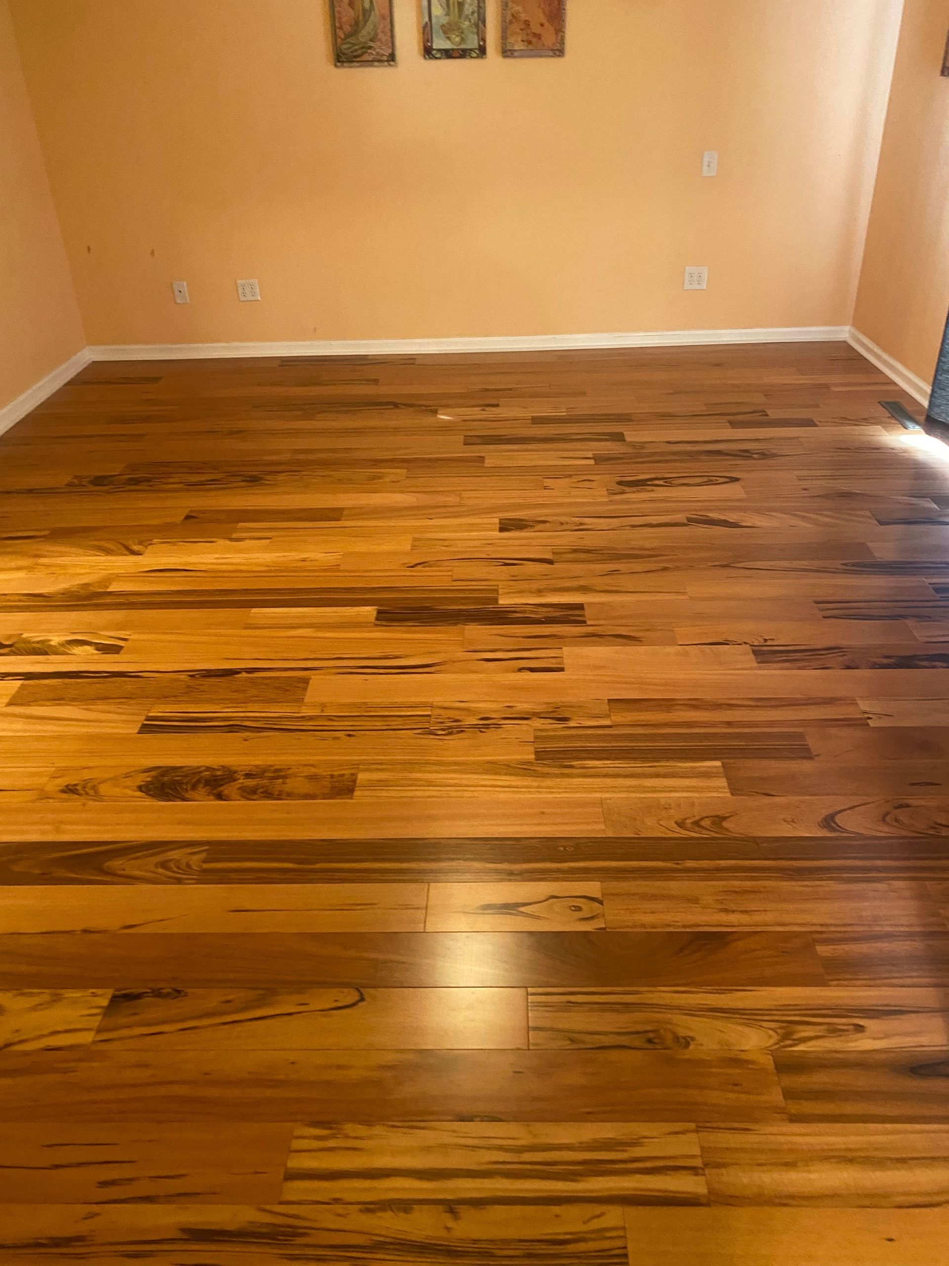 A living room with hardwood floors and yellow walls.