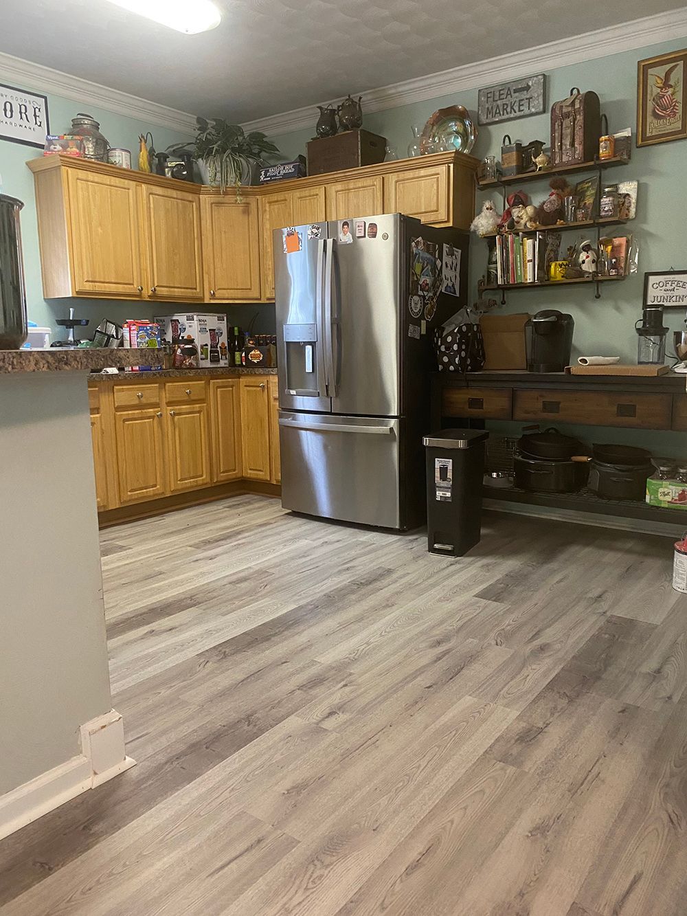 A kitchen with stainless steel appliances and wooden cabinets.