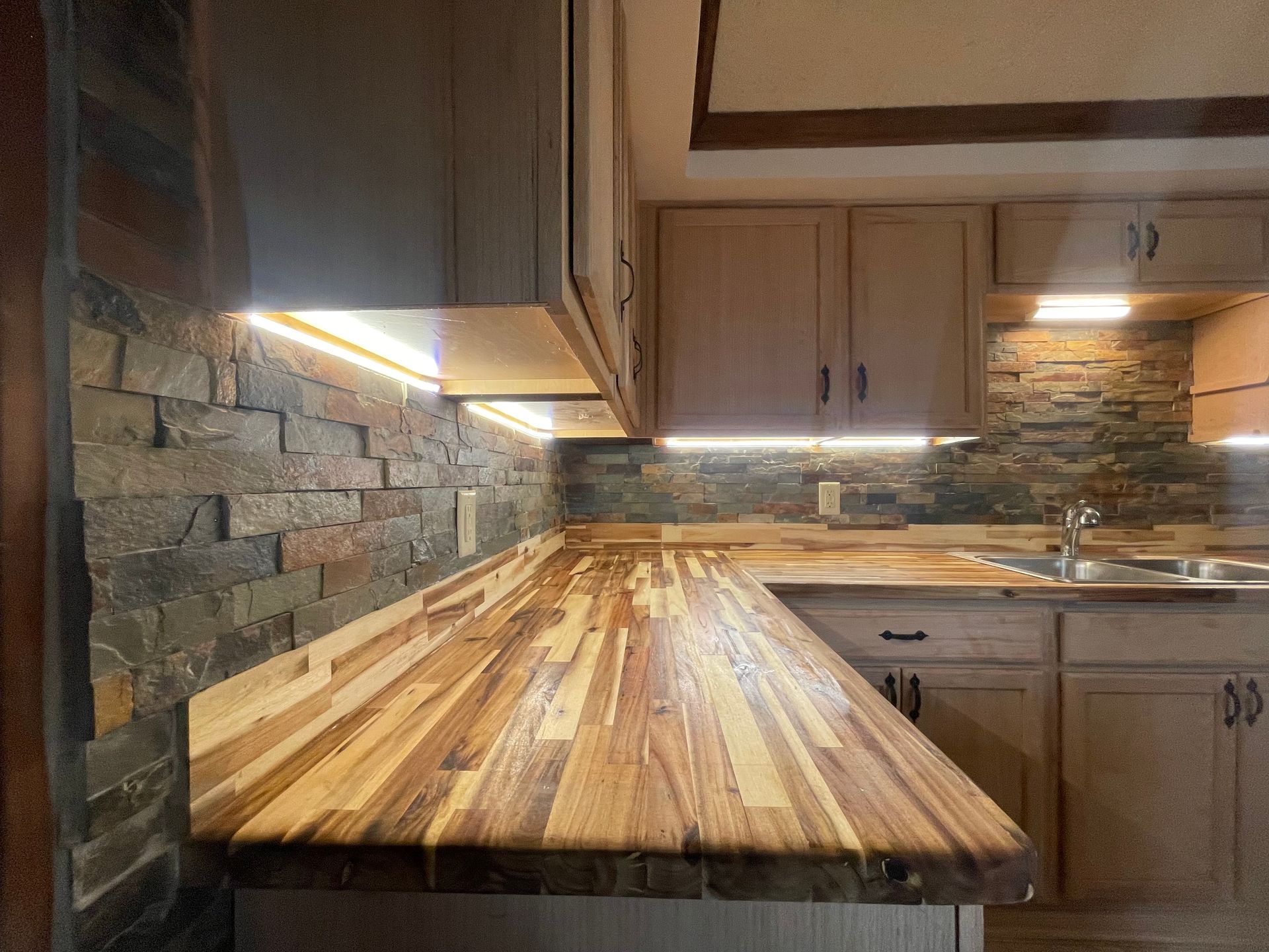 A kitchen with a wooden counter top and a sink