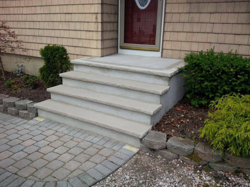 A set of stairs leading up to the front door of a house