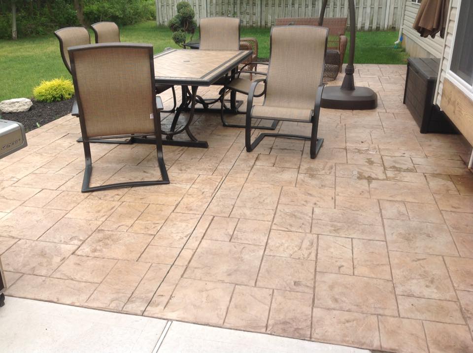 A patio with a table and chairs and an umbrella