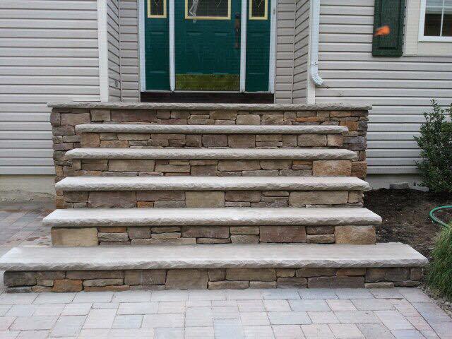 A set of stone steps leading up to the front door of a house