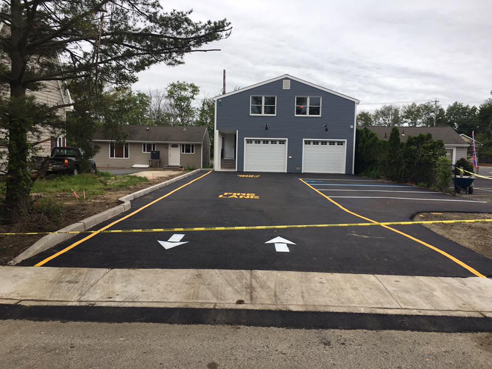 A driveway leading to a house with two garages