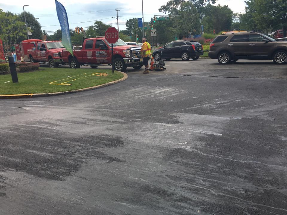A stop sign is in the middle of a parking lot