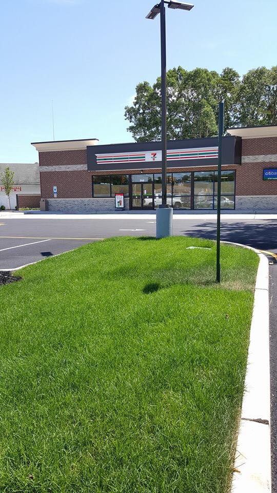 A large brick building with a lot of grass in front of it.