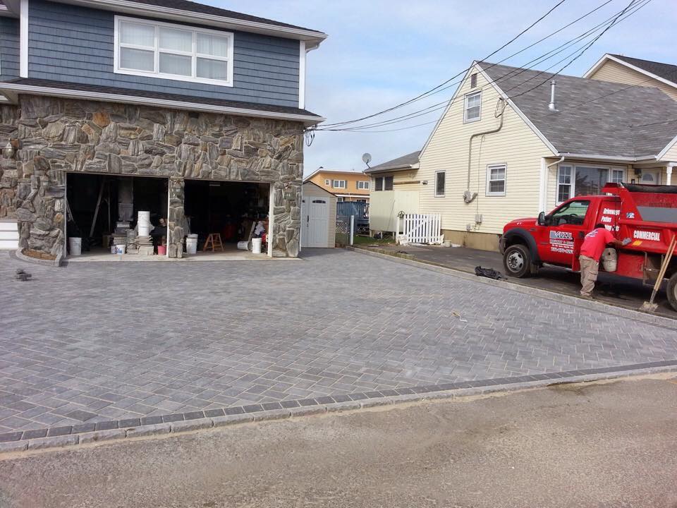A red truck is parked in front of a house