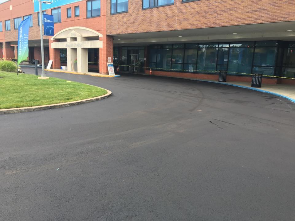 A patio with a table and chairs under a ceiling fan