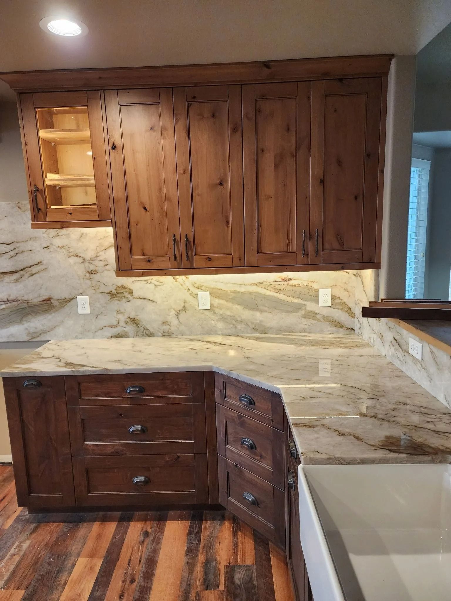 Kitchen with wood cabinets, granite countertops, and under-cabinet lighting.