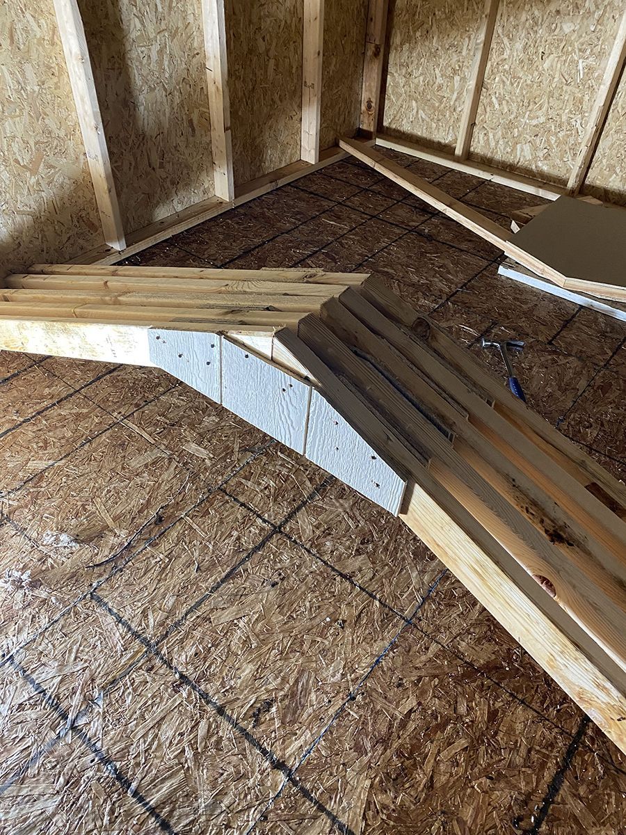 A bunch of wood sitting on top of a tiled floor.