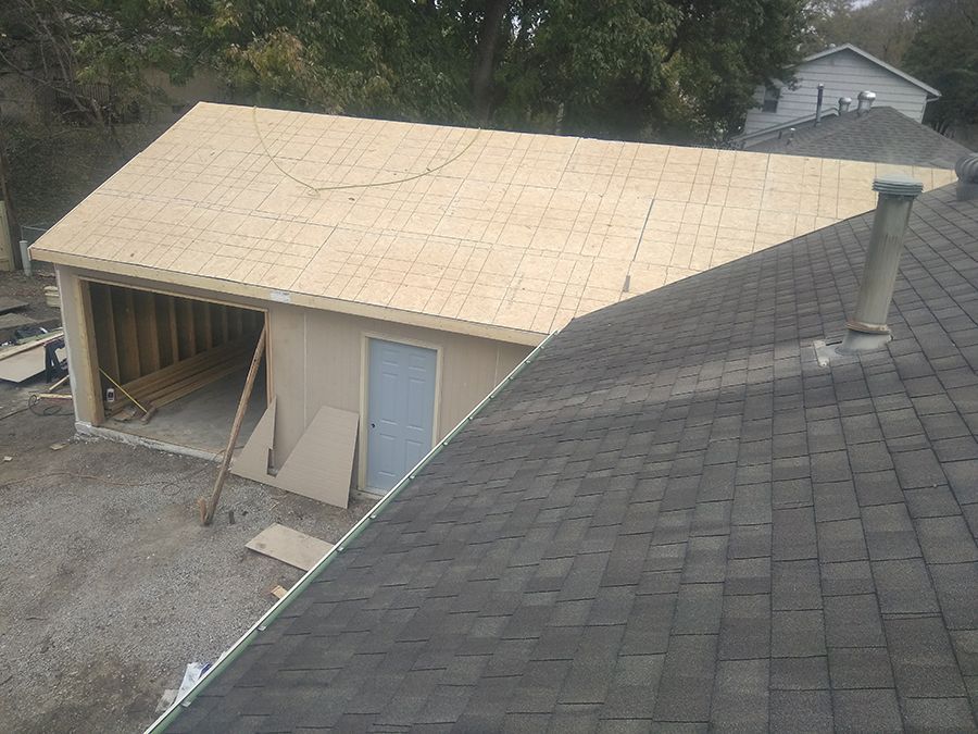 A garage is being built and the roof is being installed.