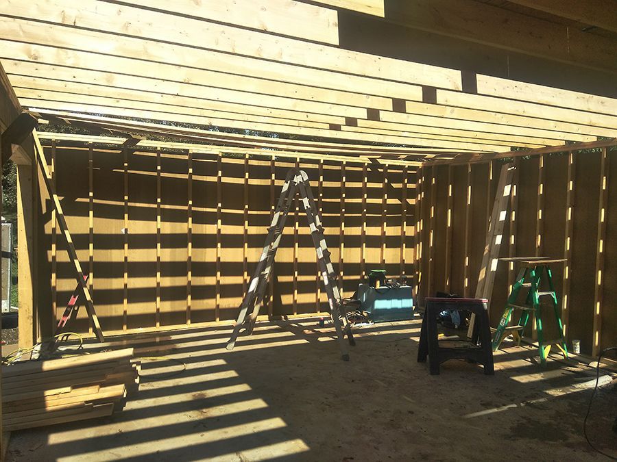 A ladder is sitting in the middle of a wooden structure.