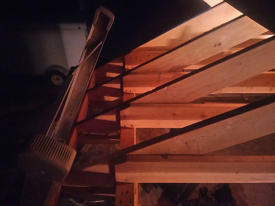 A ladder is sitting on top of a wooden structure.