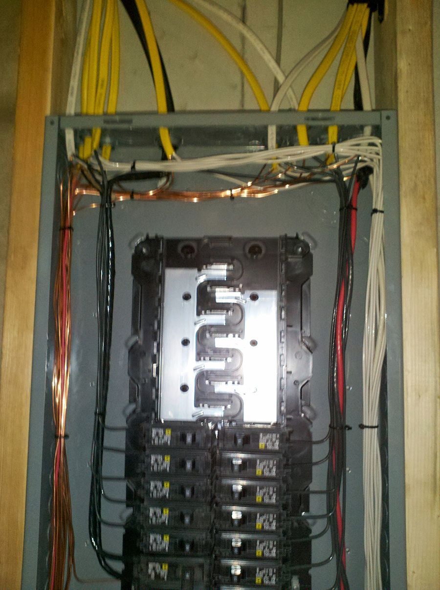 A close up of a electrical box with a bunch of wires coming out of it.