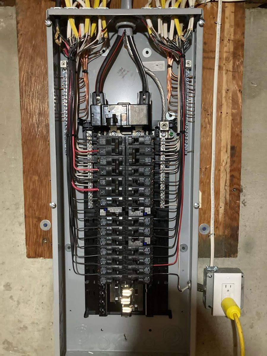 A electrical panel is sitting on top of a wooden table.
